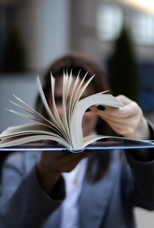 Woman flipping pages of a book.