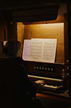 A person plays music on an organ.