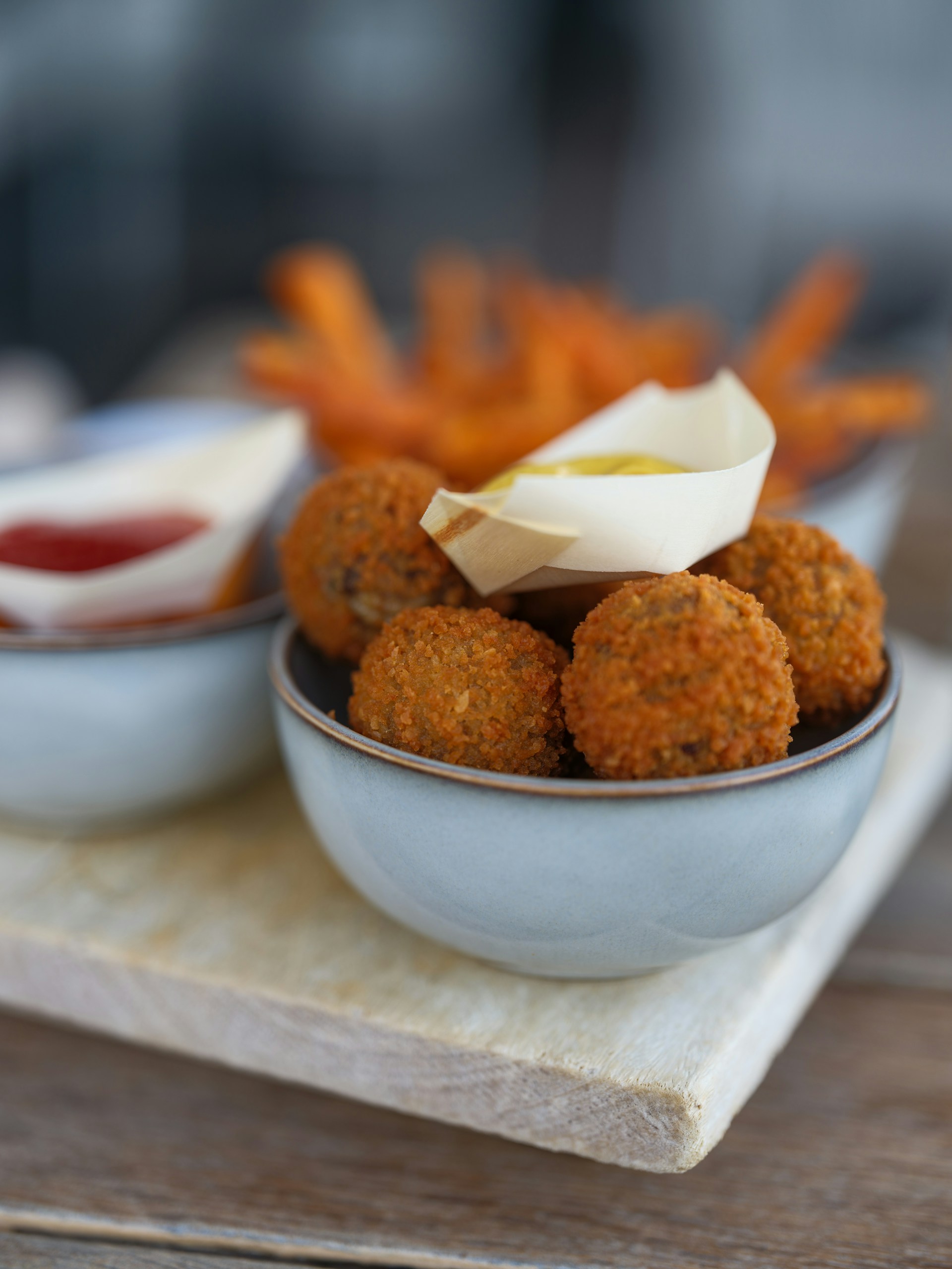 Fried food and sauces in stylish bowls.