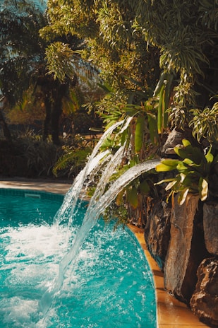 Water cascades into a turquoise pool in nature.