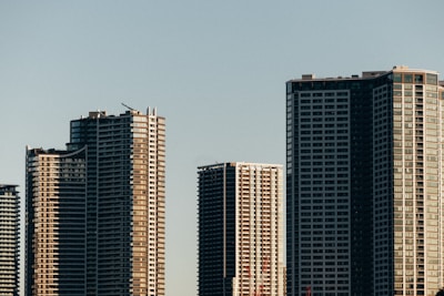 Skyscrapers stand tall against a clear, blue sky.