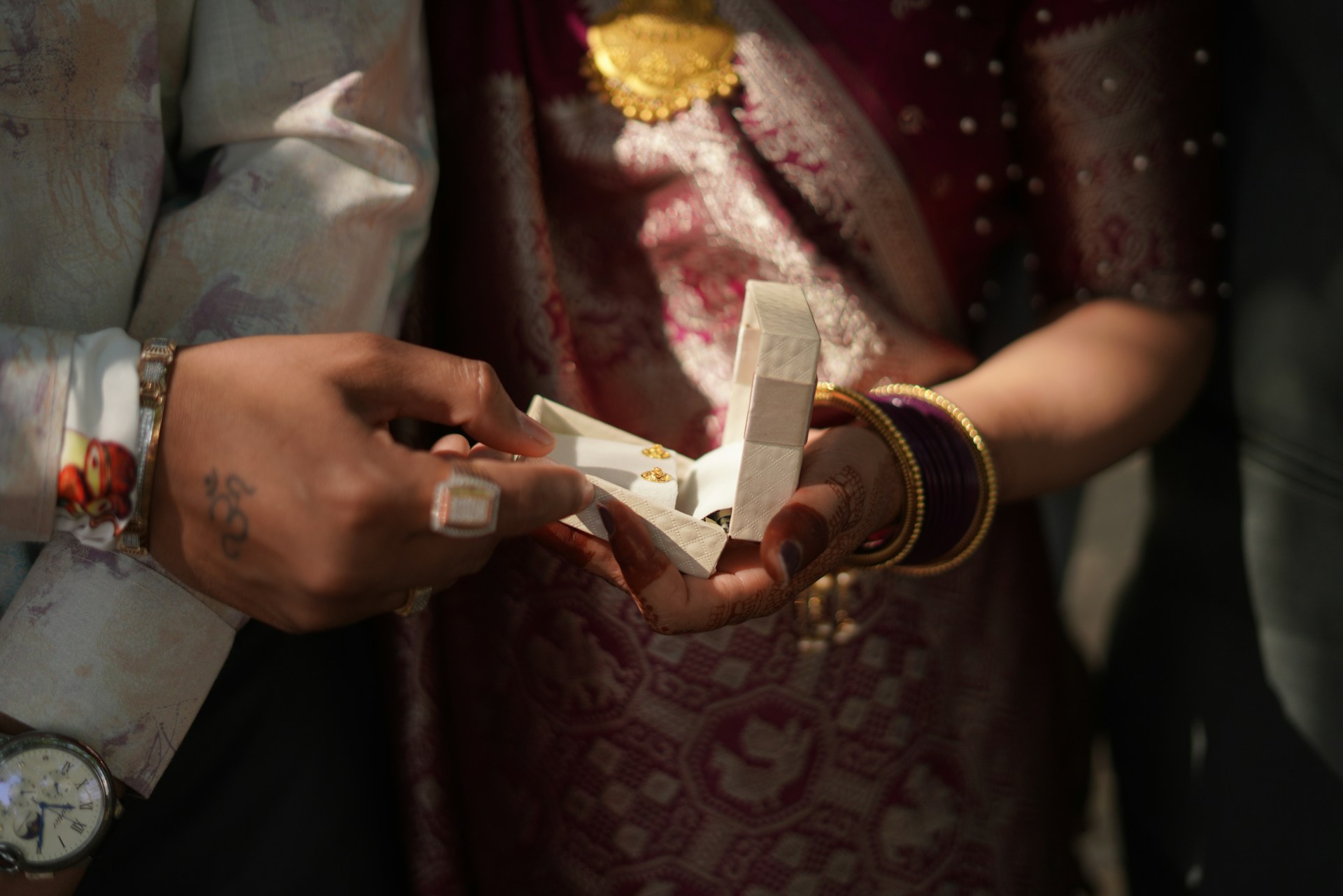 An engagement ring box is being opened.
