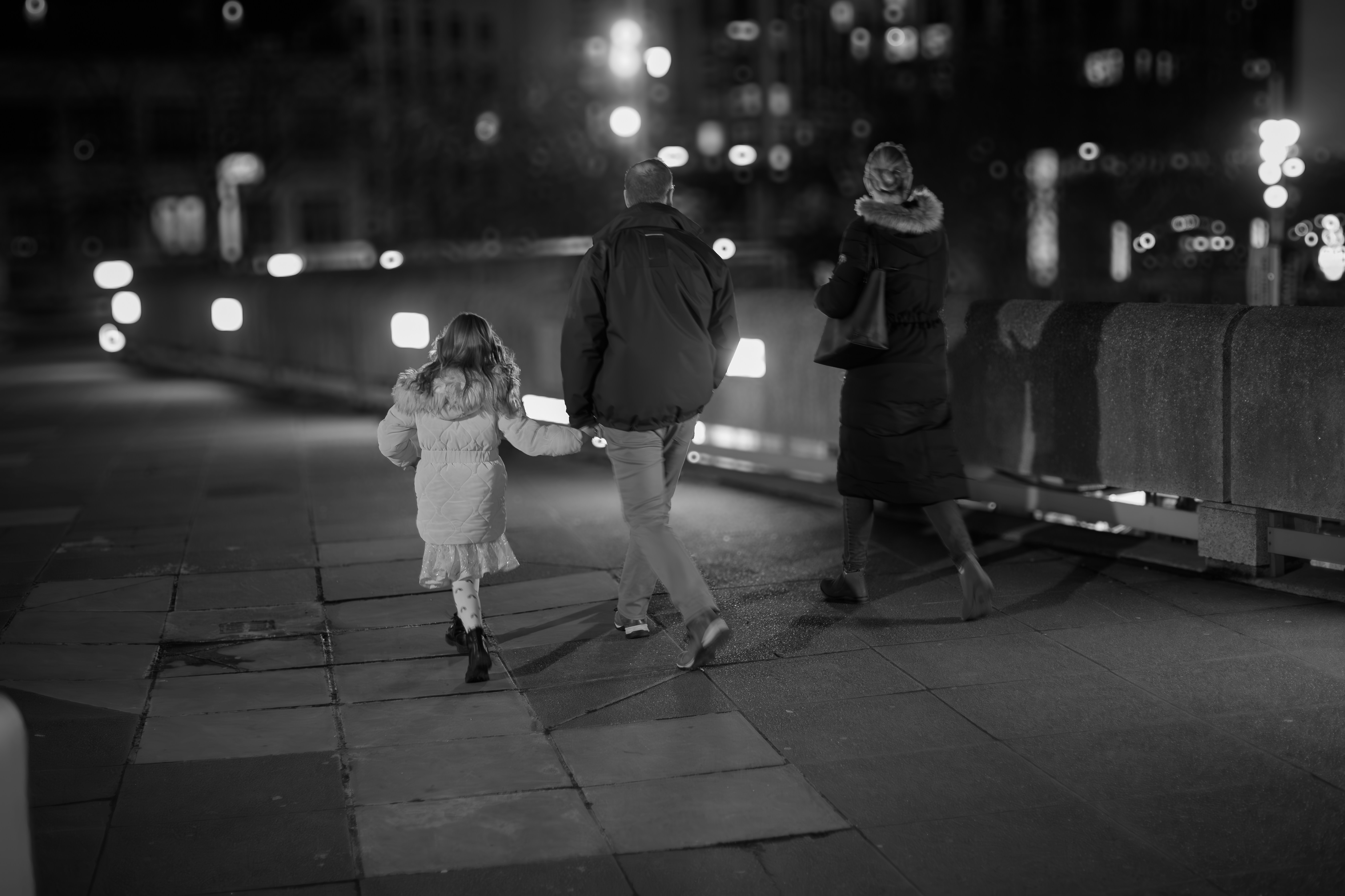 A family walks together at night.
