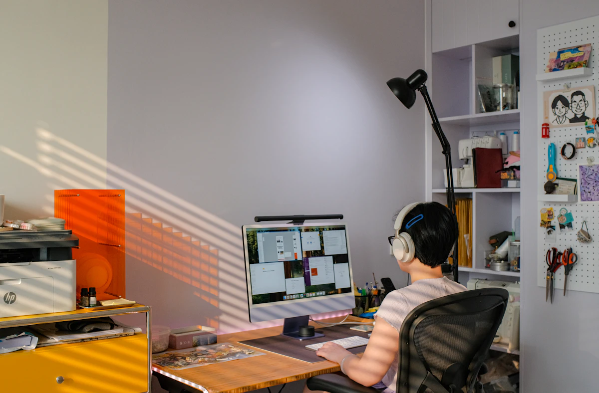 Person attending a remote training session on a desktop computer in a home office