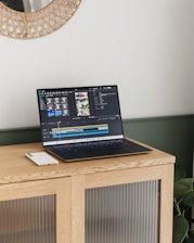 A laptop is displaying video editing software.