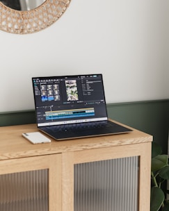 A laptop is displaying video editing software.