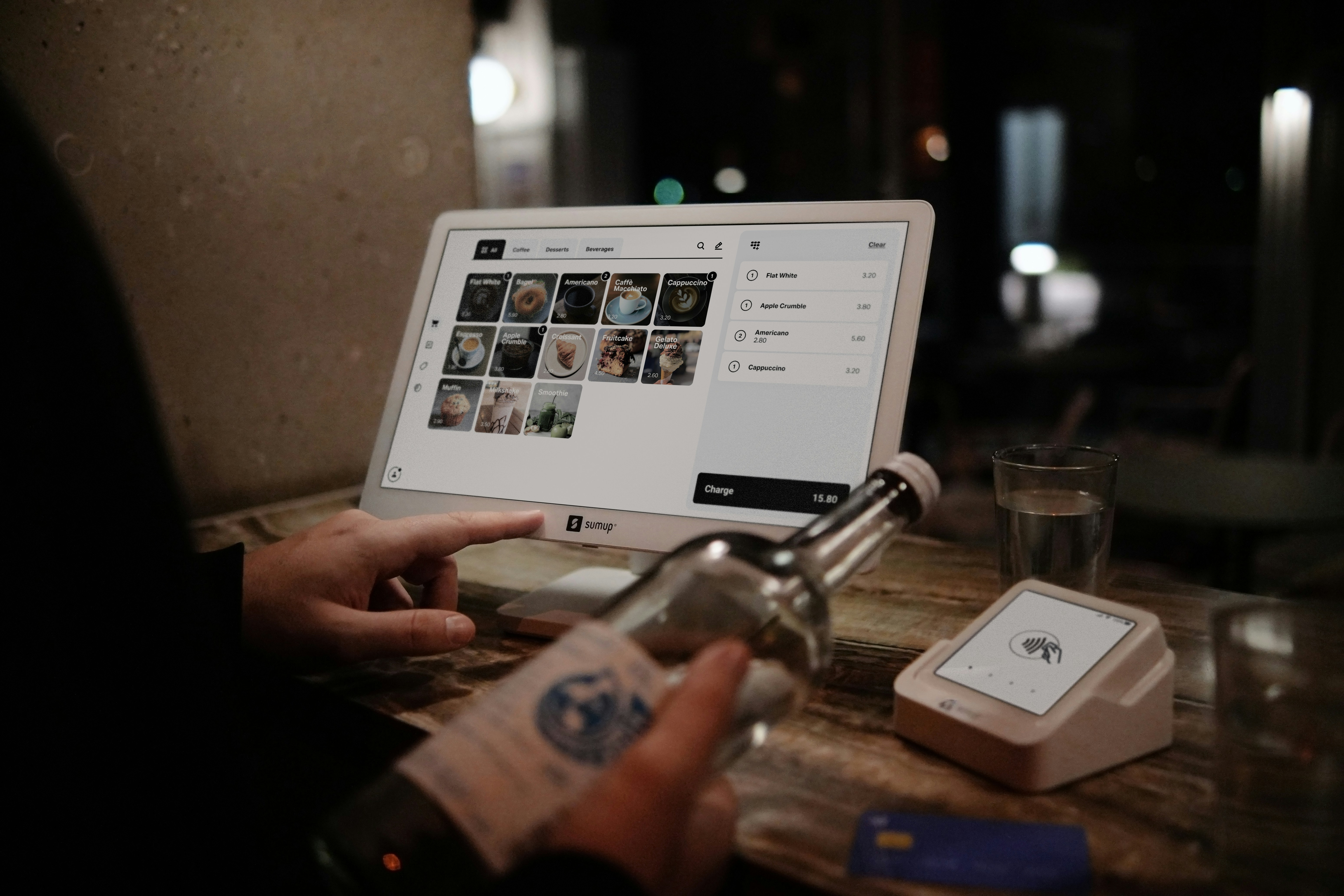 A person is using a laptop at a restaurant.