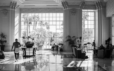 A luxurious lobby with large windows and people.