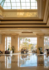 Luxurious hotel lobby with a glass ceiling.
