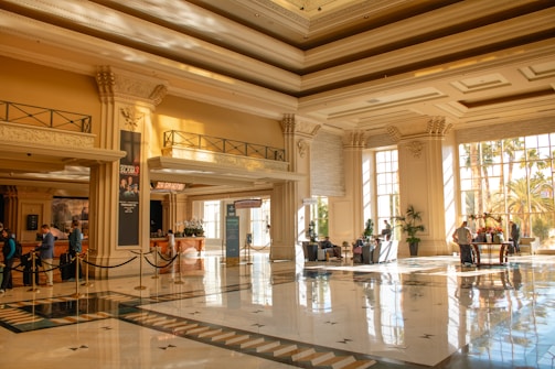 A grand hotel lobby filled with sunlight.