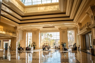 An elegant, well-lit lobby with tall pillars.