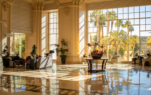 Elegant lobby with large windows and sunlight.