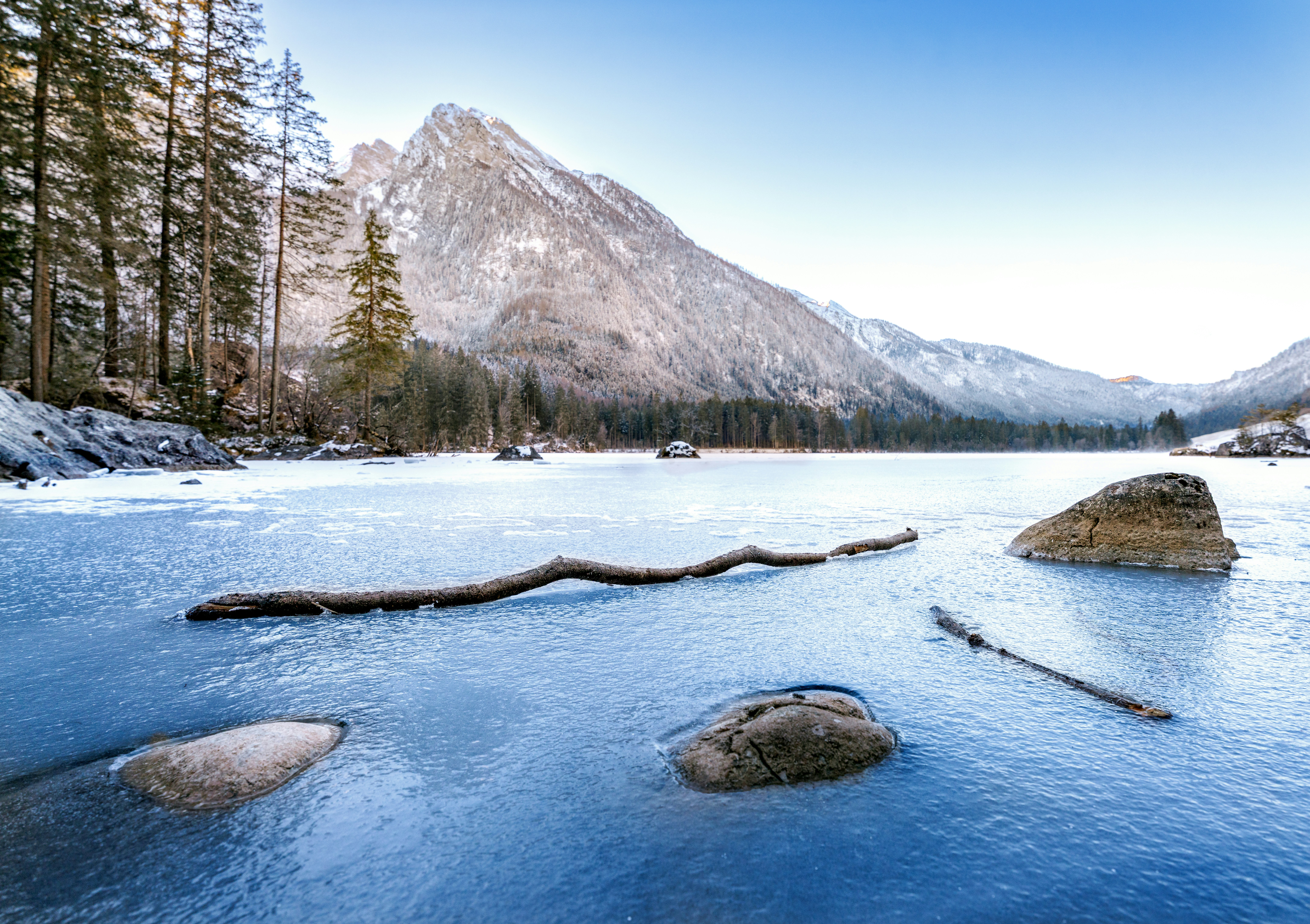 Snowy mountain and frozen lake landscape.