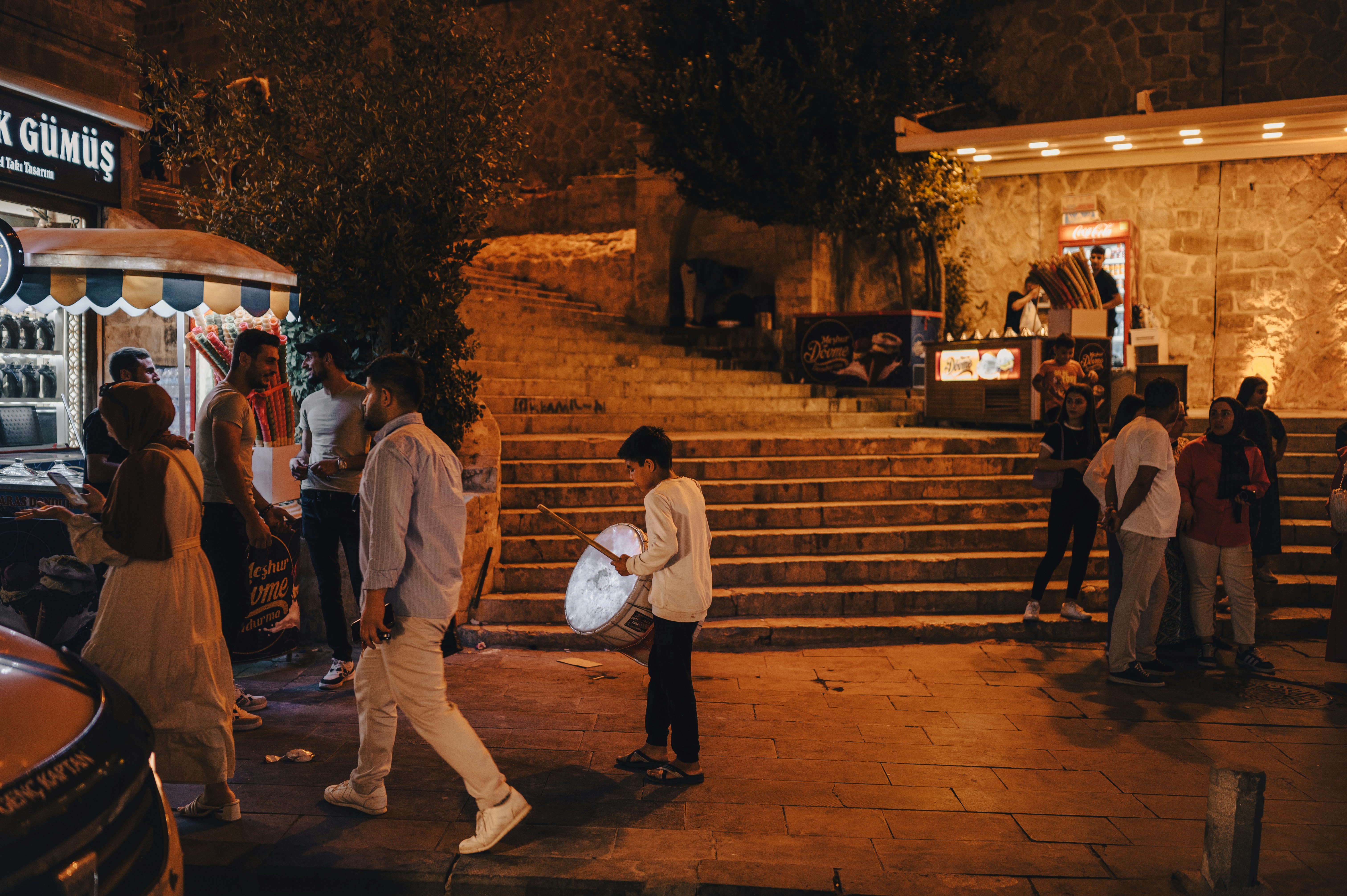 People Gather on a City Street at Night