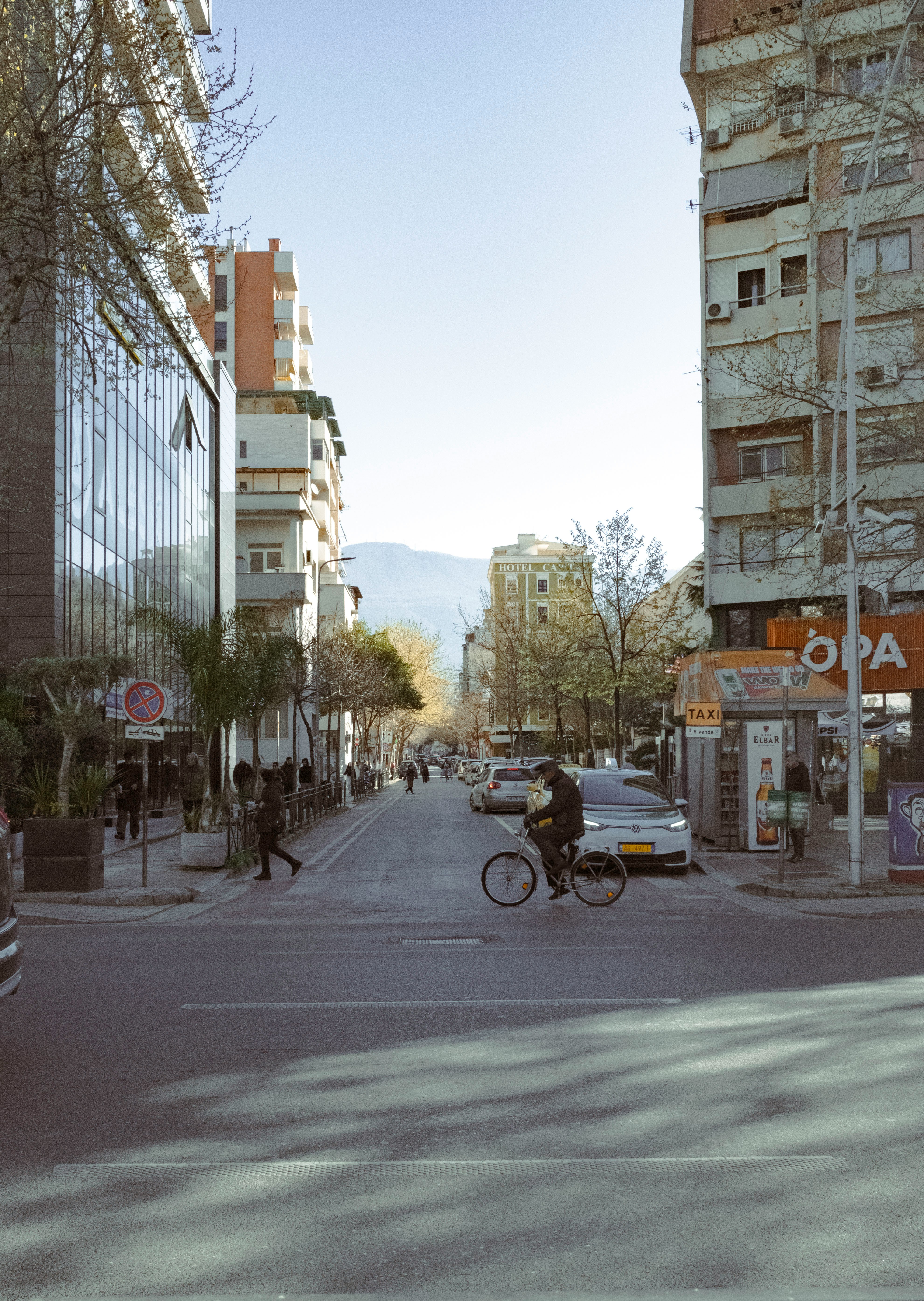A vibrant street scene in Tirana, Albania, with traditional architecture and people walking