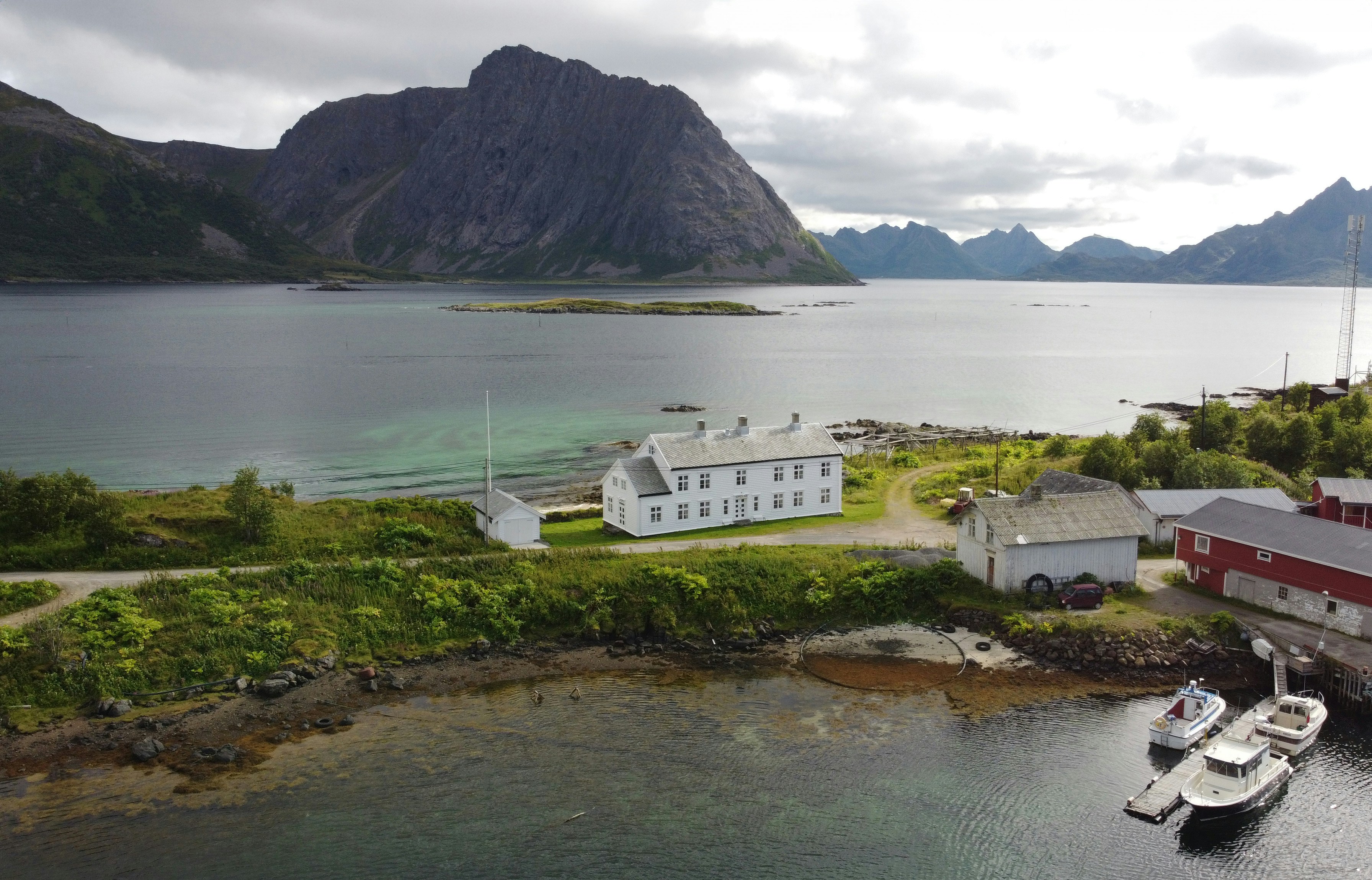 A scenic view of a building beside a lake.