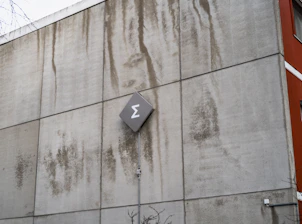 A wall has stains and a symbol on it