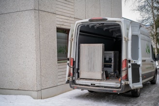A delivery van with its back doors open.