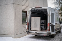 A delivery van with its back doors open.