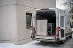 A delivery van with its back doors open.