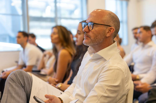 A group of people attend a business conference.