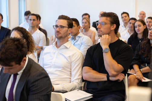 People attentively listening during a presentation or meeting.