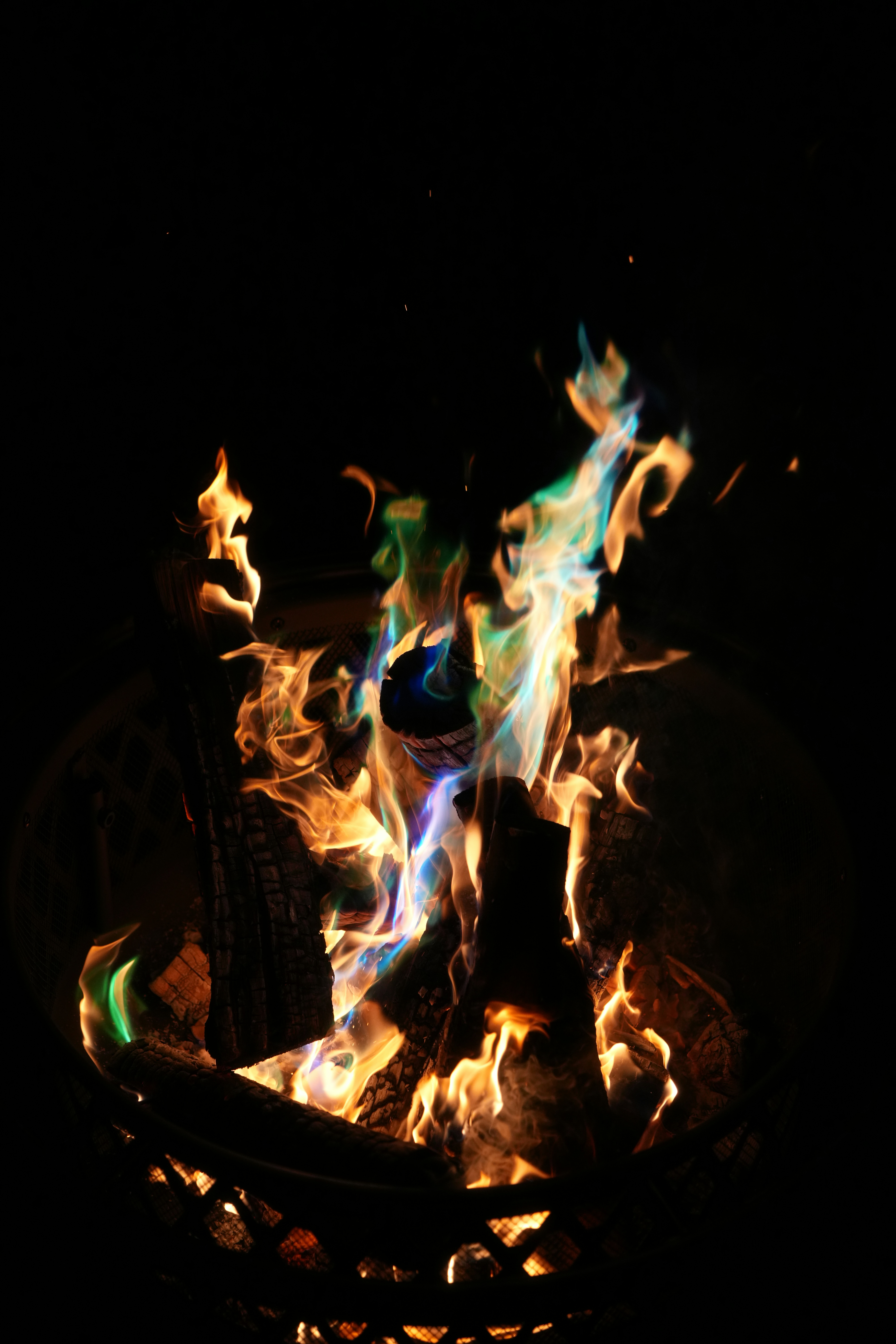 Colorful flames burn brightly in the night.