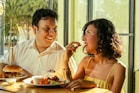 A couple shares food and laughs together.