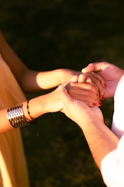Couple holding hands with affection and support.