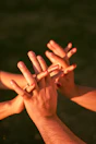 Hands are intertwined, showing support and connection.