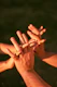 Hands are intertwined, showing support and connection.