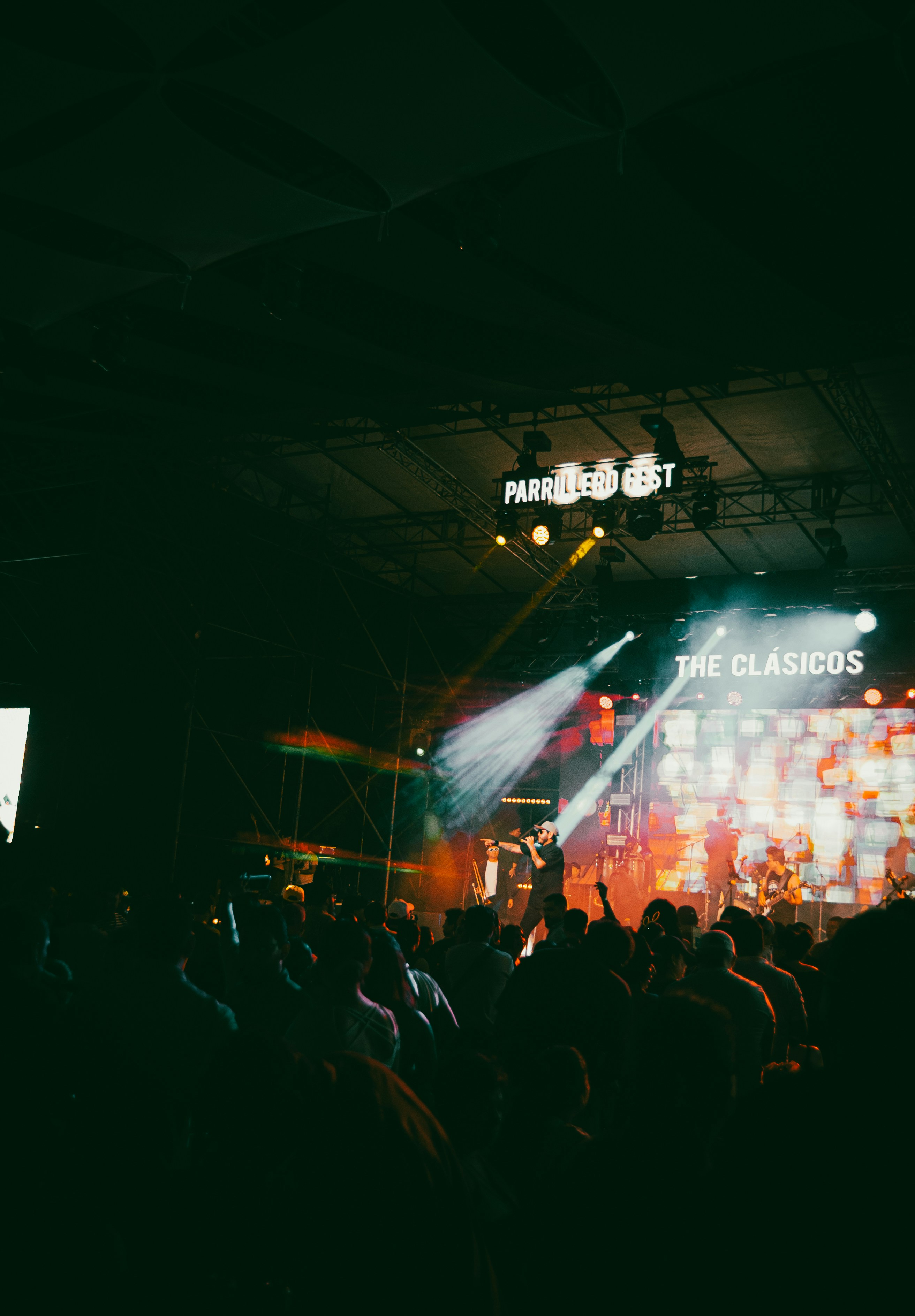 A concert stage is illuminated with vibrant lights.
