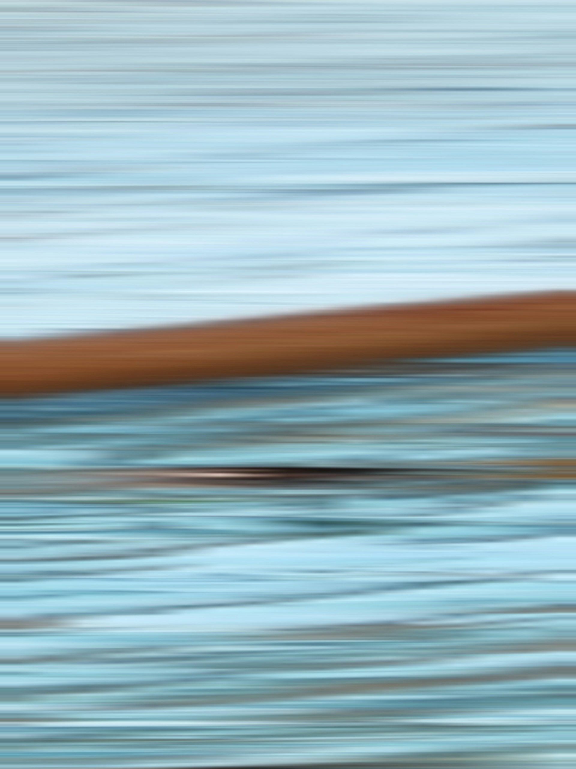 Blurry, abstract shot of water and a wooden object.
