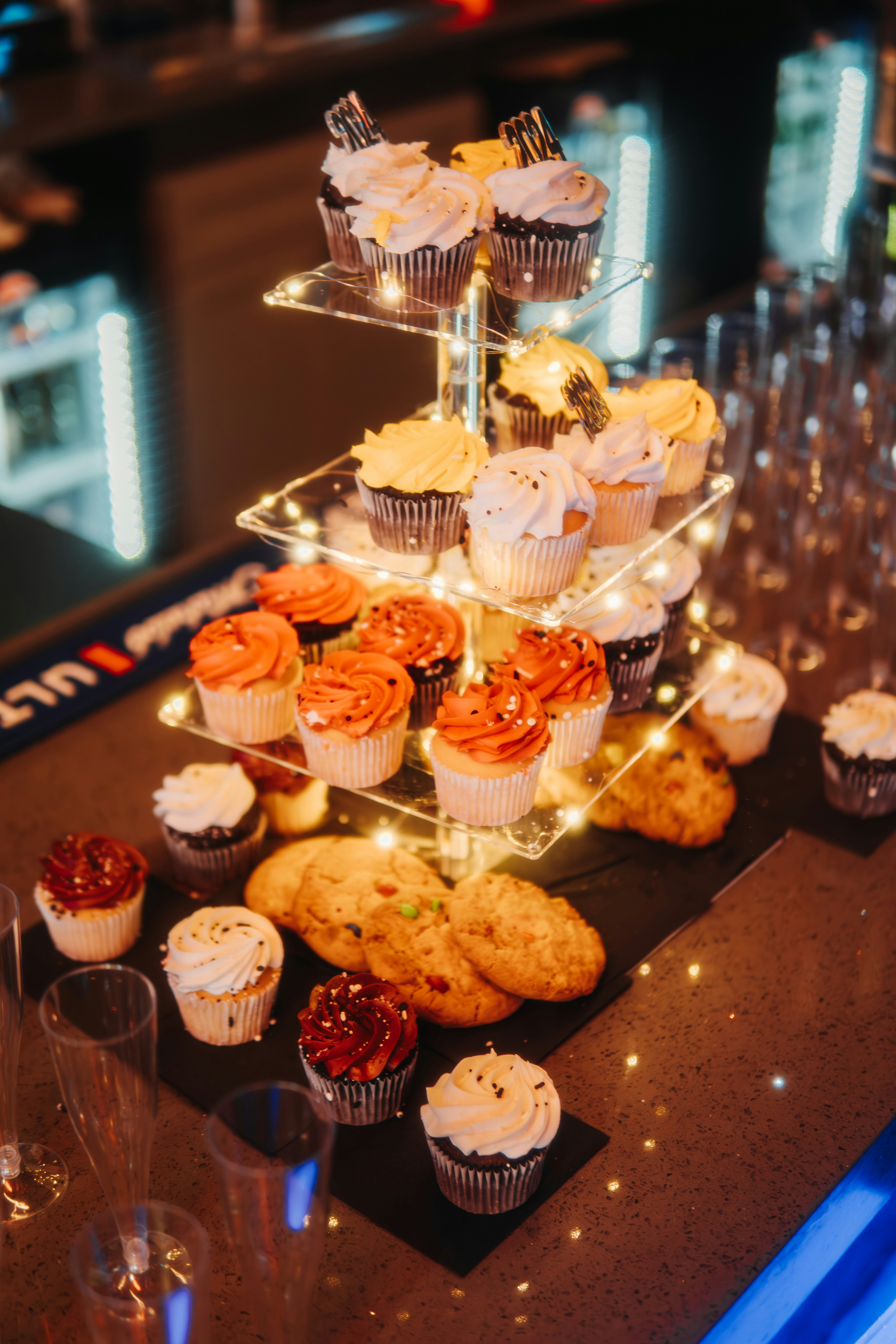 Delicious cupcakes are arranged on a tiered stand.