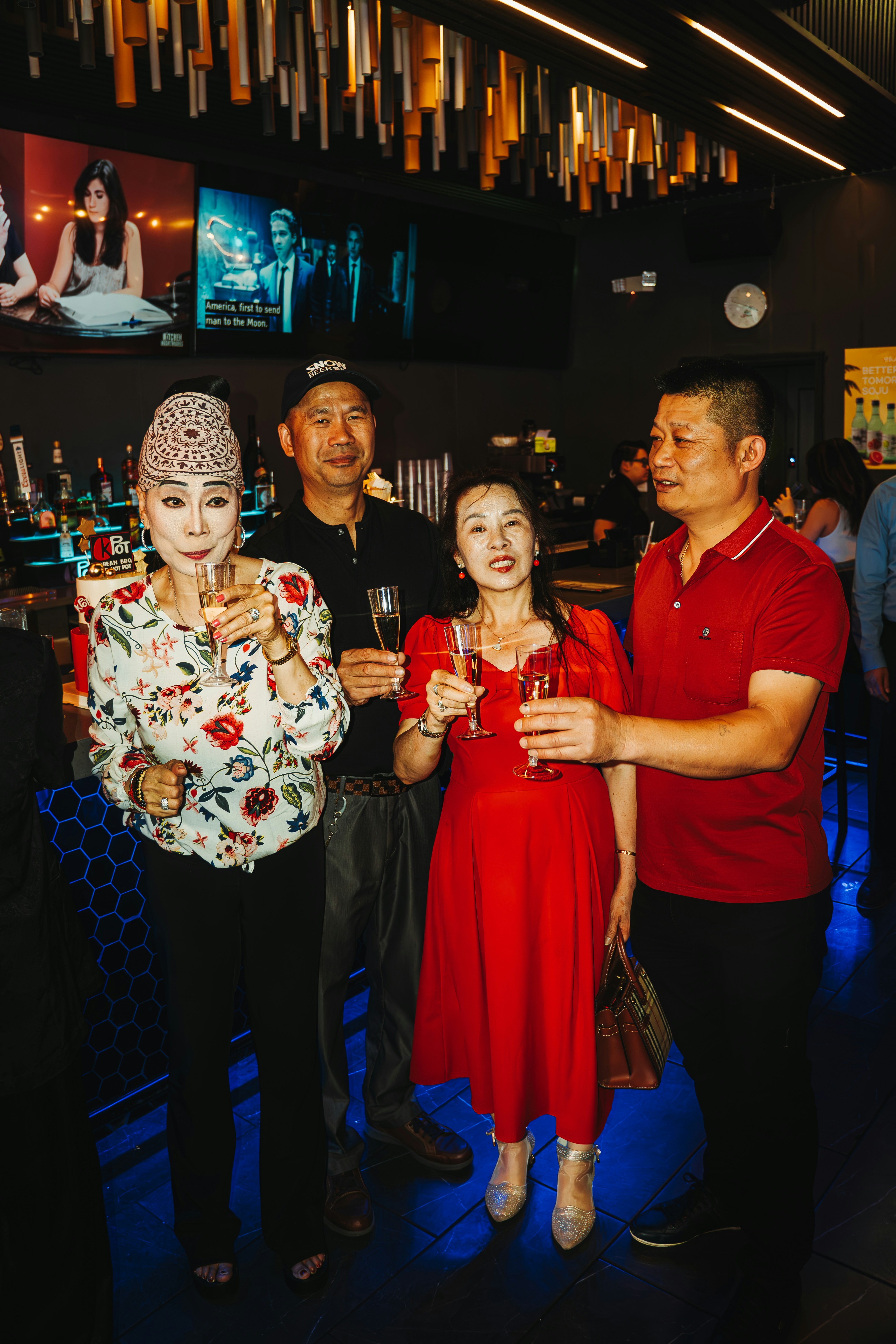 People celebrate with champagne in a bar.