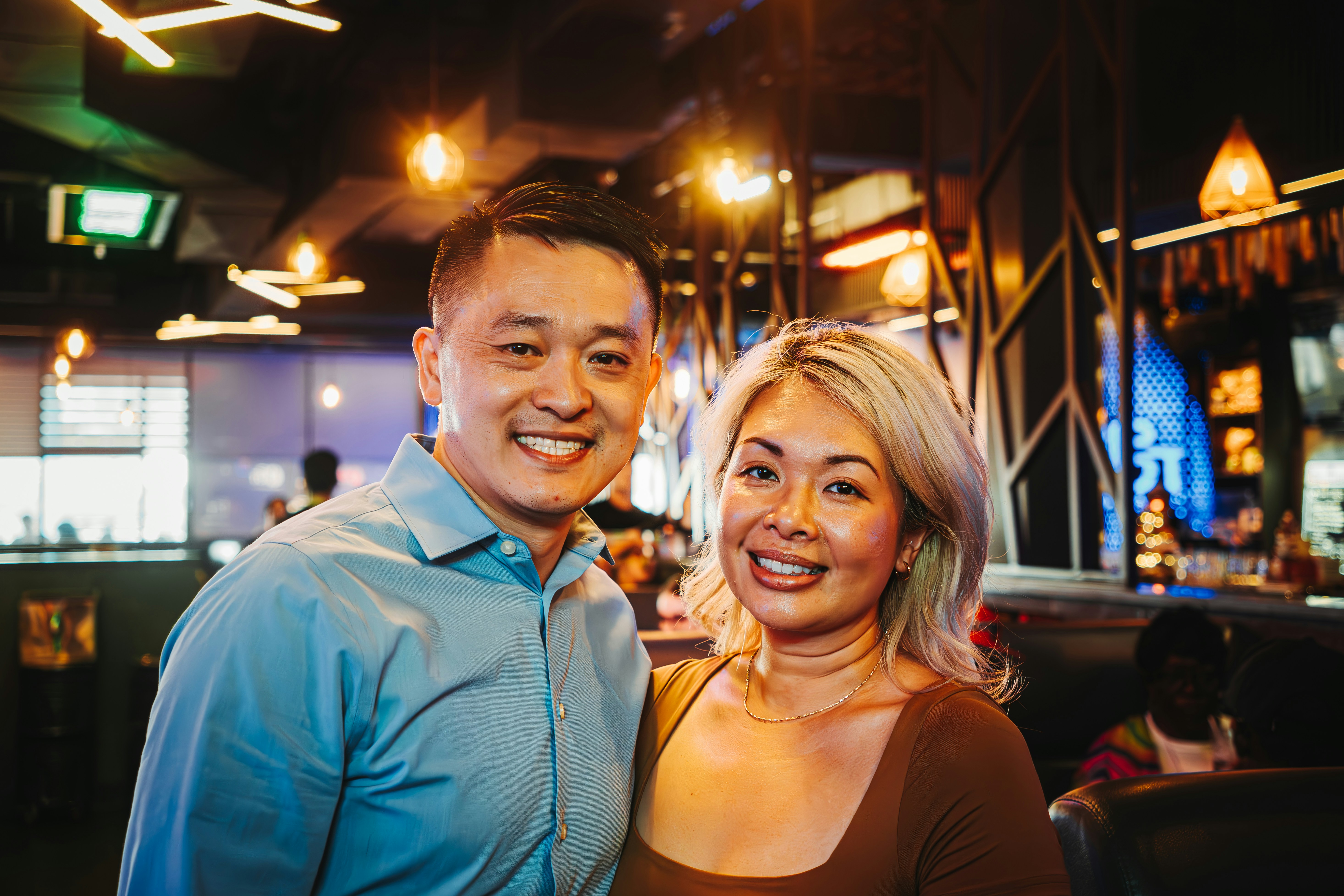 Happy couple posing for a picture at a restaurant.