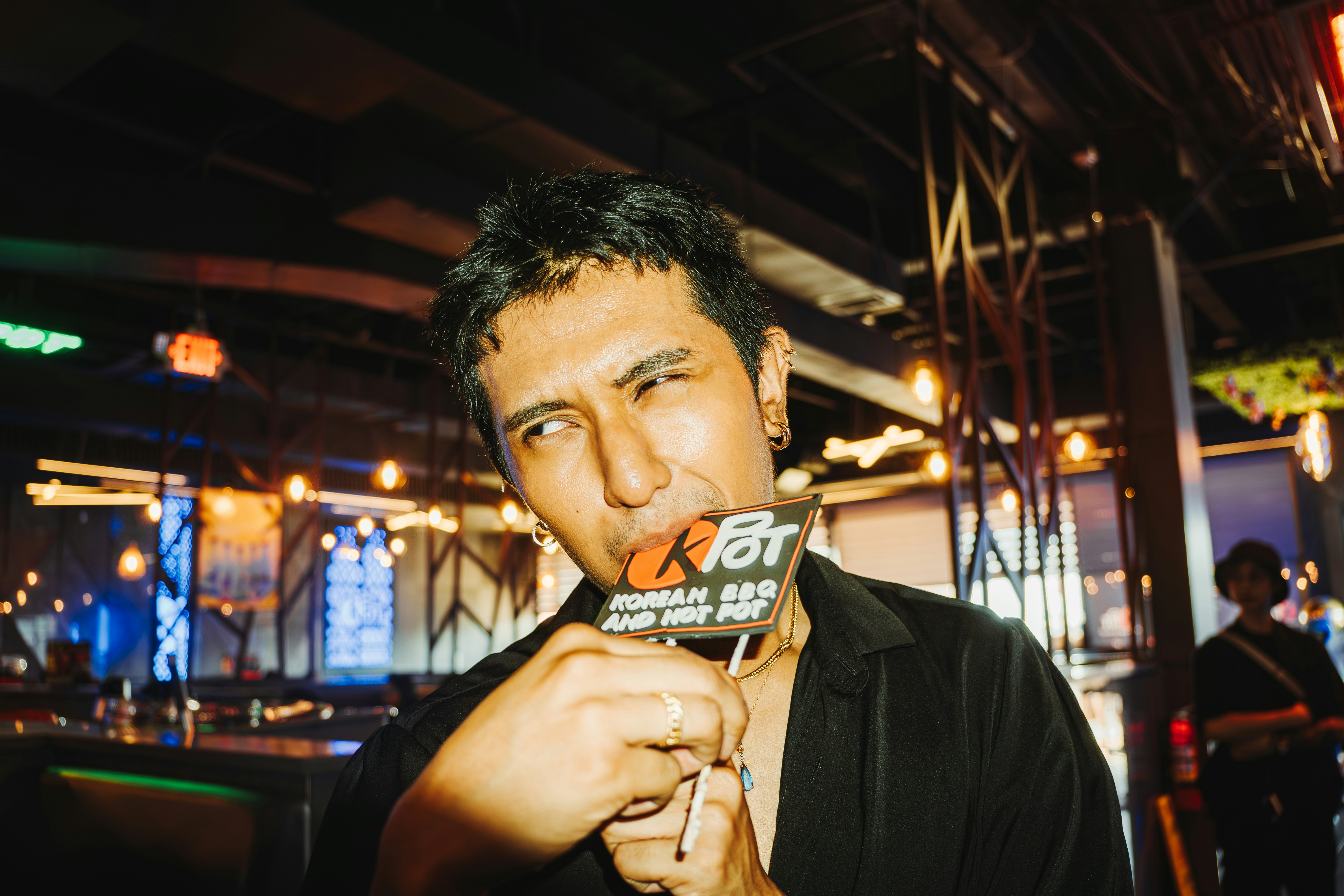 A man is licking a small card.