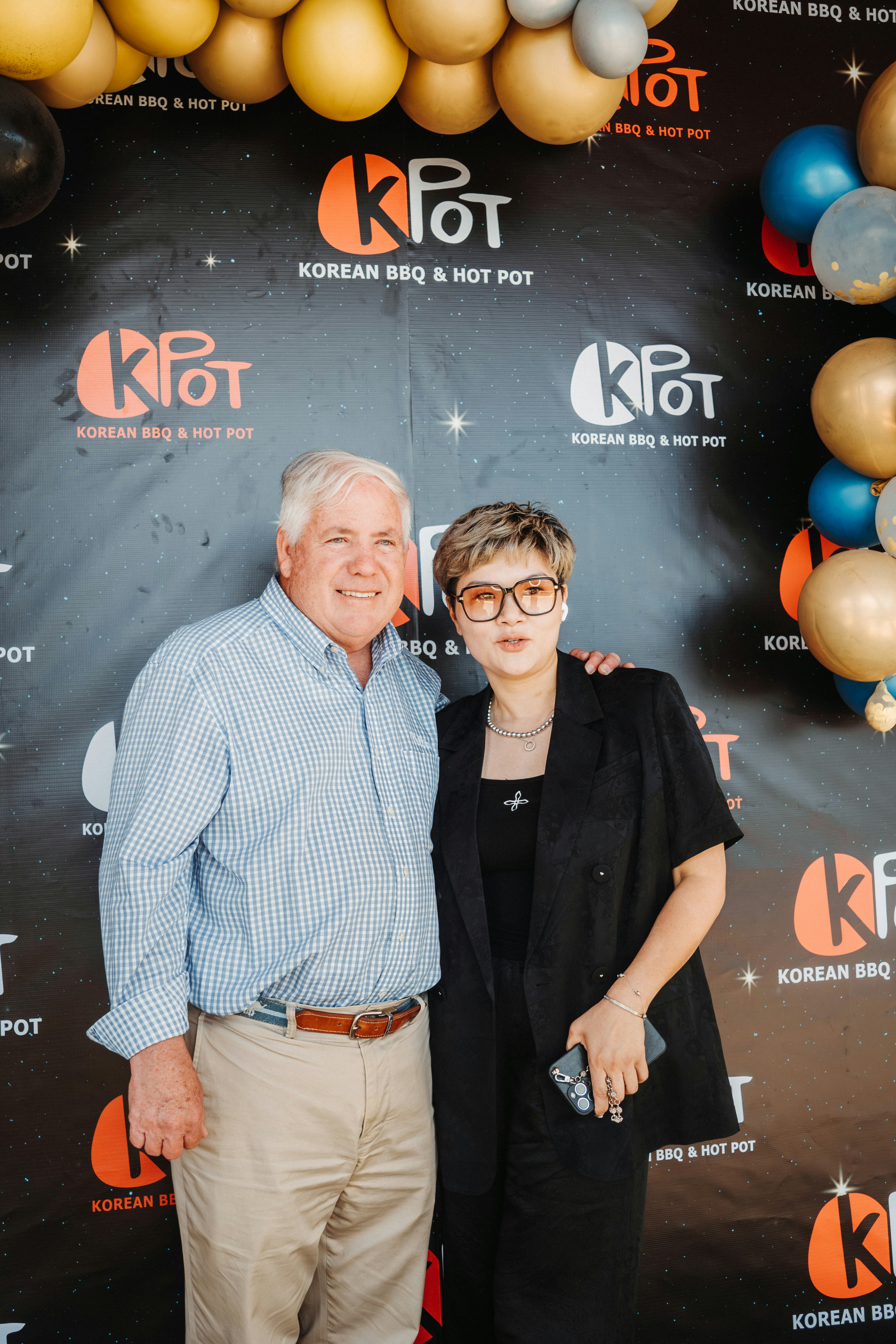 Two people pose for a photo at k-pot restaurant.