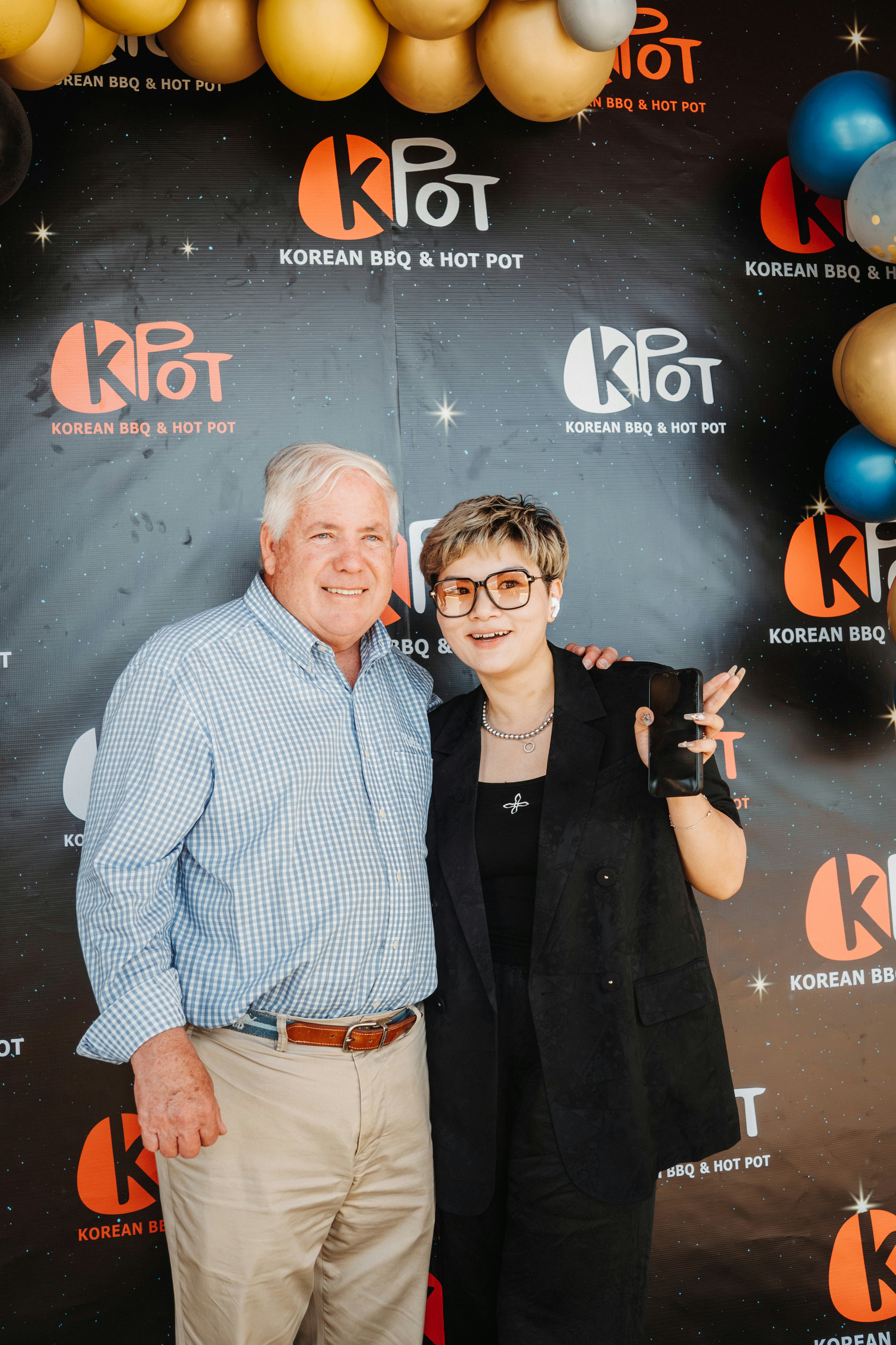 Two people pose at the k pot korean bbq restaurant.