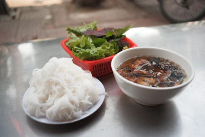 Bun cha dish of grilled pork with rice vermicelli noodles and dipping broth
