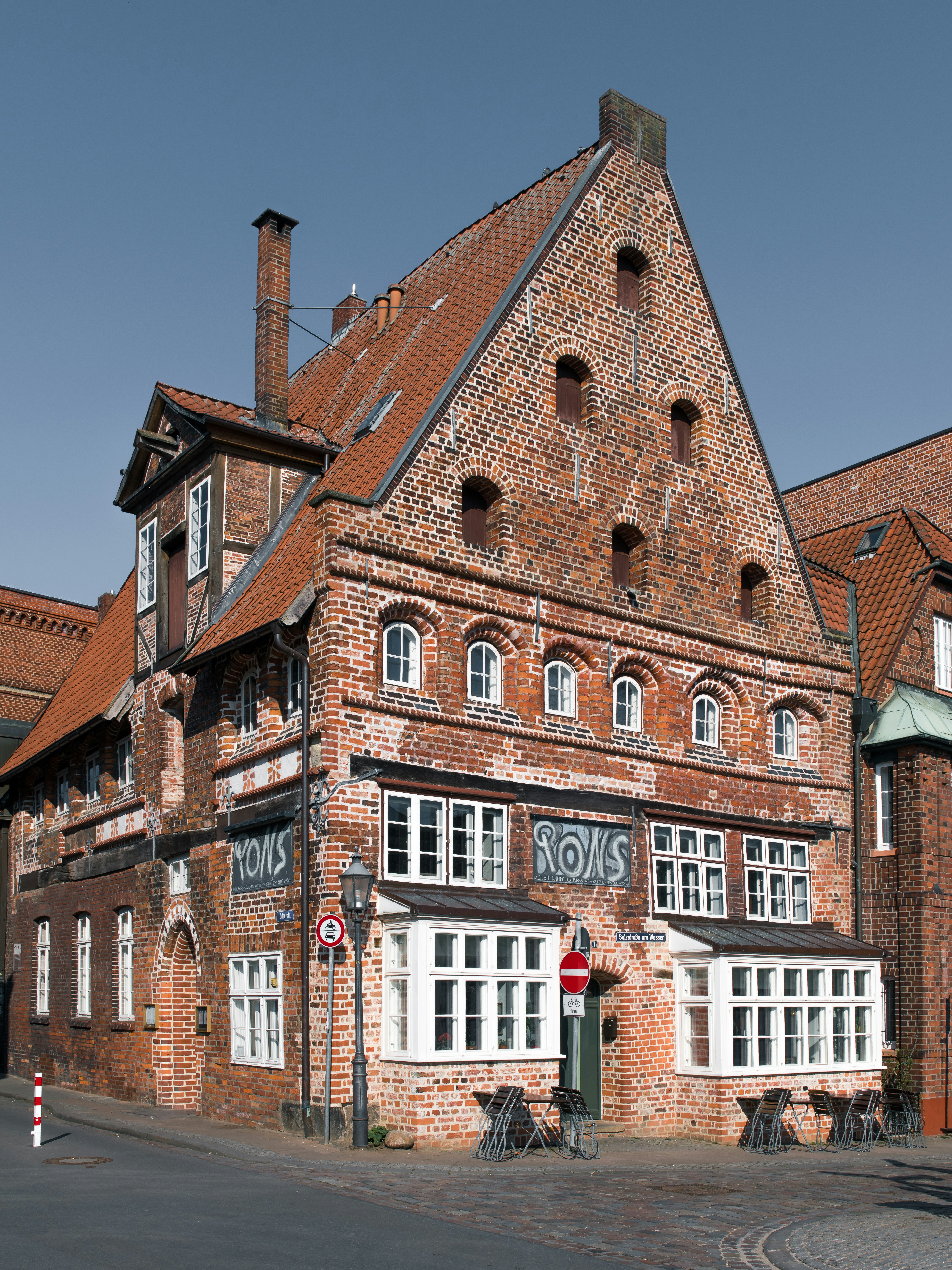 An old brick building with a steep roof.