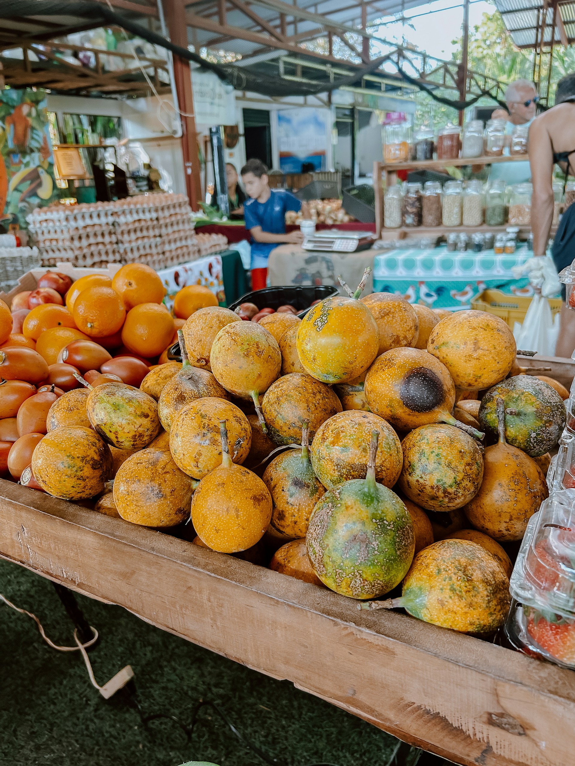 Fresh fruits displayed at a sunny outdoor market.
