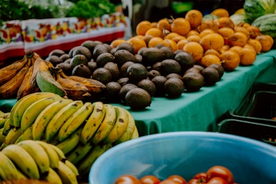Fresh fruits are displayed at a vibrant outdoor market.
