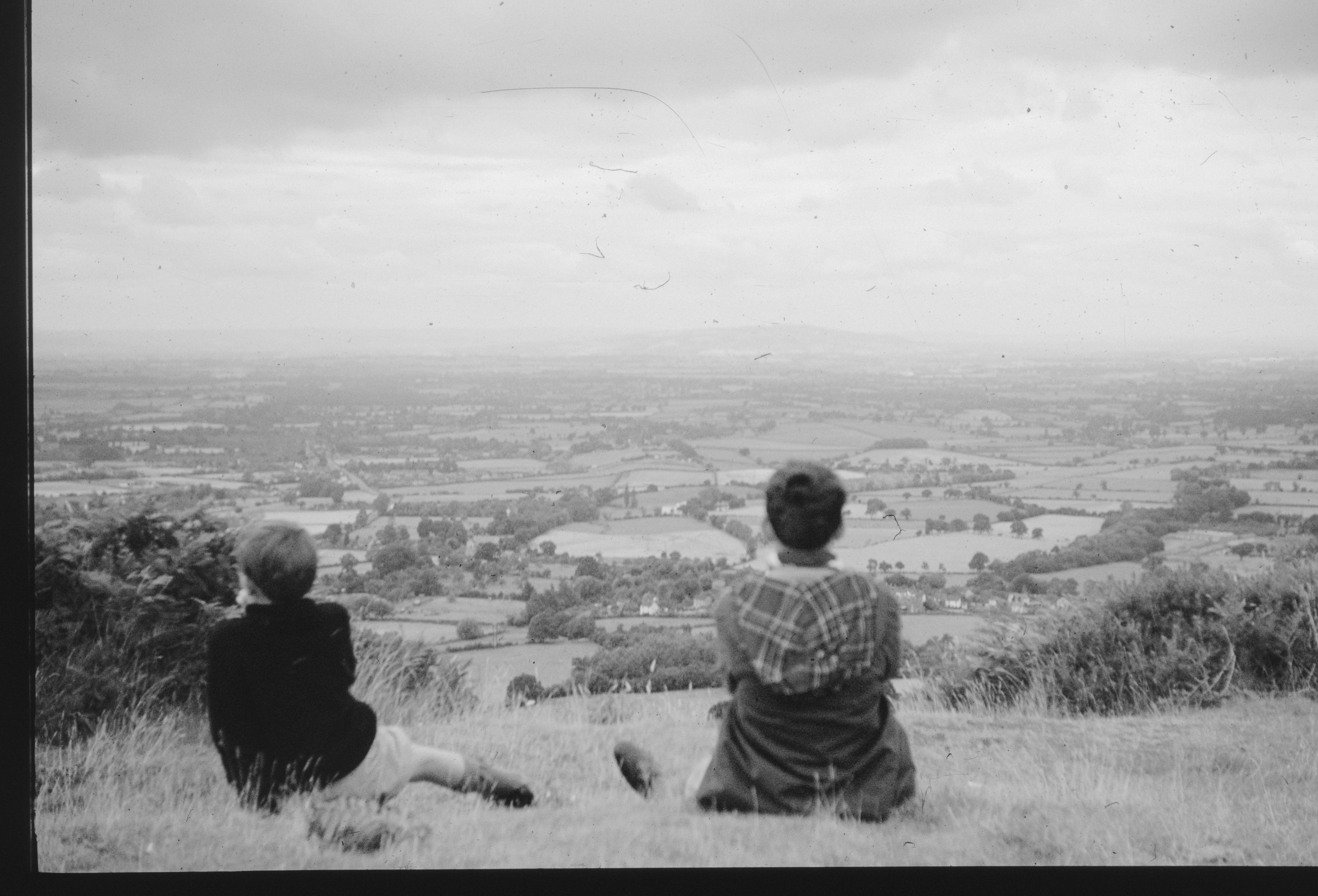 Two people admire the distant landscape.