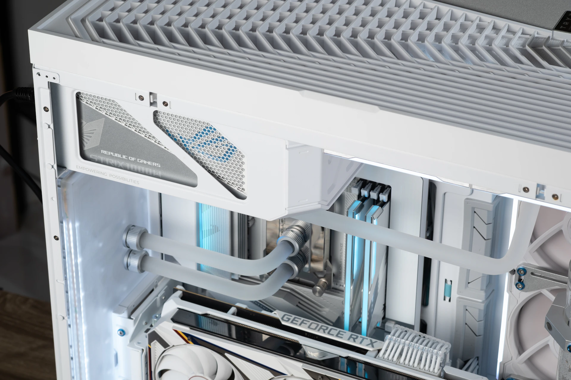 A white computer case with custom liquid cooling.