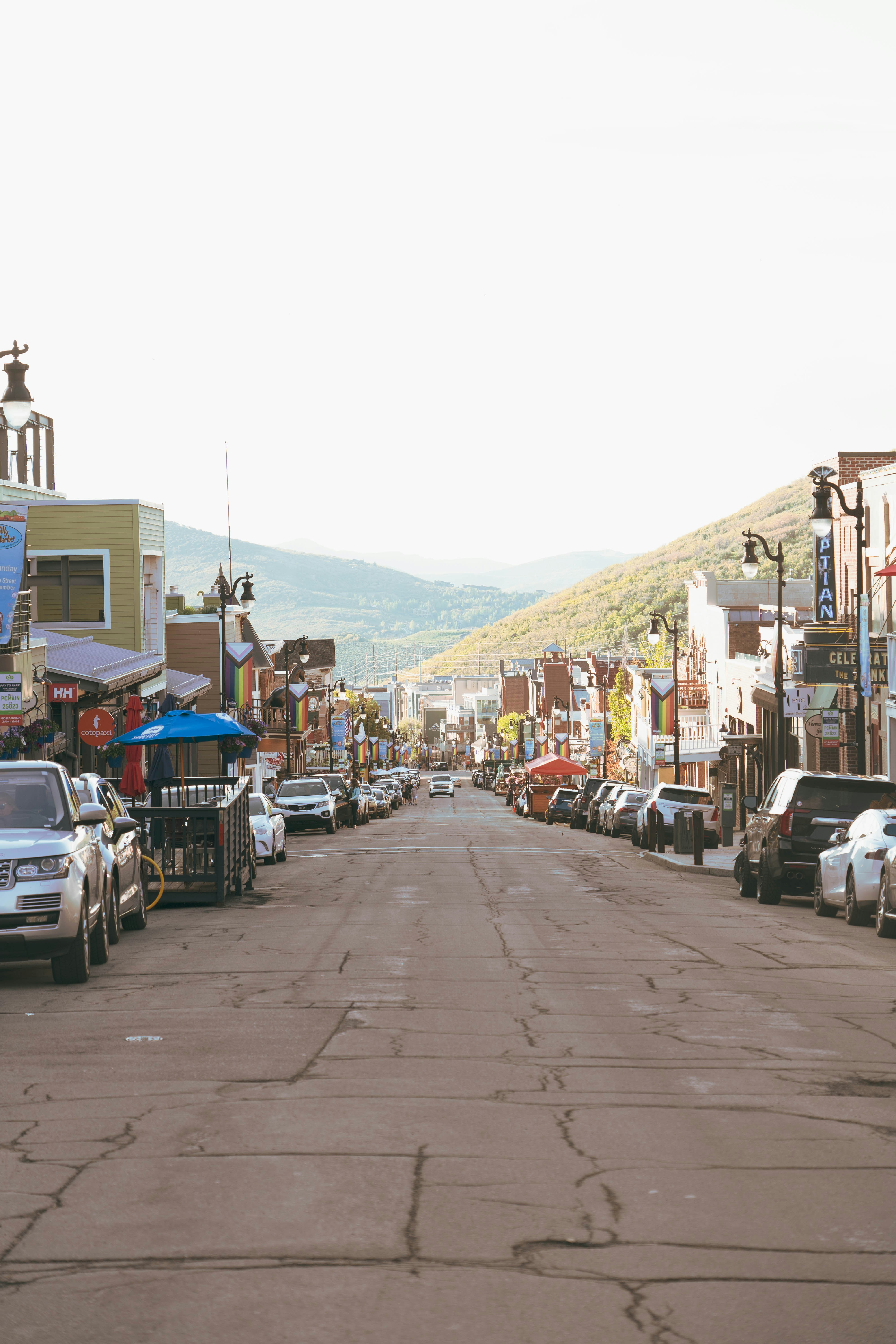 A street lined with cars and buildings.