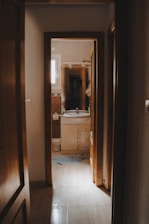 A bathroom is visible through an open doorway.