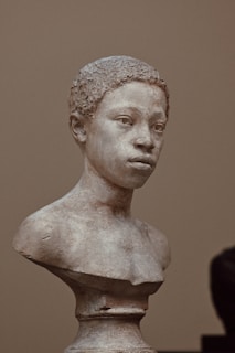 A bust of a young person is shown.