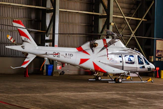 A helicopter sits inside a hangar.
