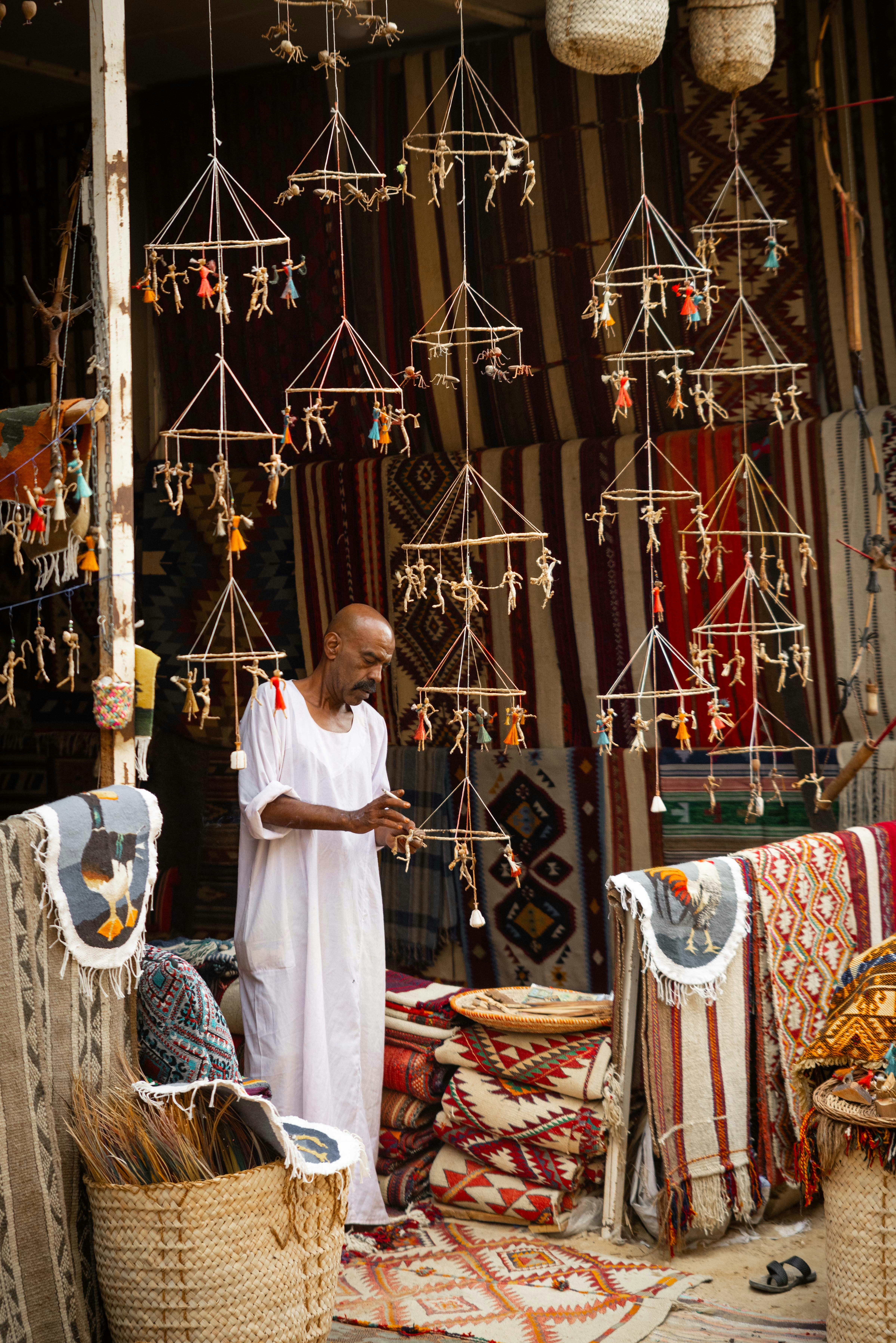 A man stands in a market stall.